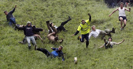 Competitors take part in the Cheese Rolling event on Coopers Hill in Gloucester